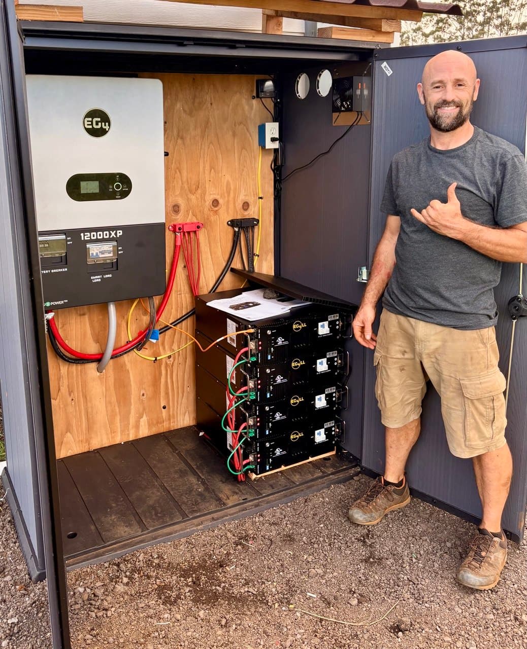 Naga standing beside an EG4 solar installation
